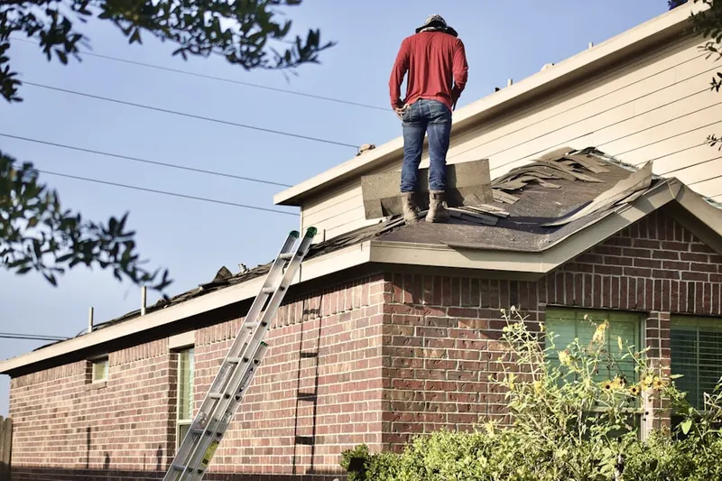 Professional roofer working on a residential roof in Martinsville